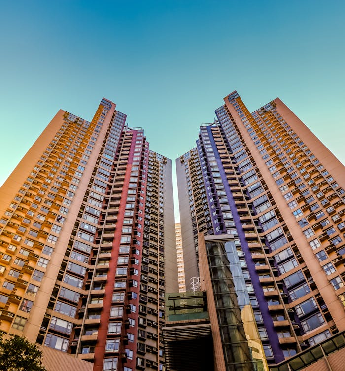 Services-01 Tall, colorful skyscrapers reaching into the blue sky in Hong Kong, showcasing modern architecture.
