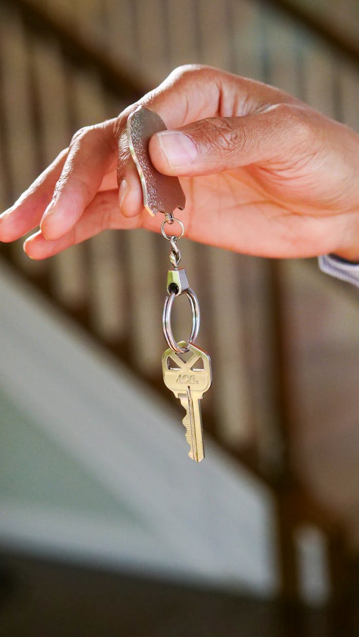 mobile-02 Close-up of a hand holding a key, symbolizing new homeownership or rental.